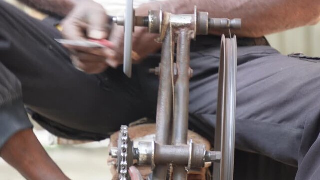 person using a manually operated knife sharpener
