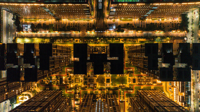 Aerial view of illuminated buildings and streets casting a warm glow over the city at night, creating a mesmerizing urban landscape, Hyderabad, Telangana, India.