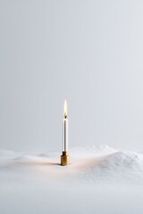 Minimalist candle burning in serene snowy landscape