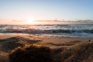 Calm sunrise over the sea with gentle waves and warm morning light
