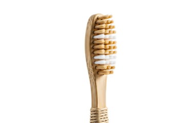 Close up of a bamboo toothbrush with natural bristles and white tips on a black background hygiene