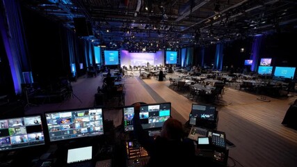 Medium shot capturing a versatile hybrid event hall equipped with flexible technology setups supporting diverse formats from conferences to virtual exhibitions.