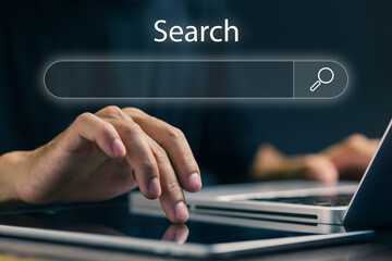 A professional searches on a digital interface using a laptop and tablet, representing online search engines, information retrieval, data discovery, SEO research, and digital marketing analysis.