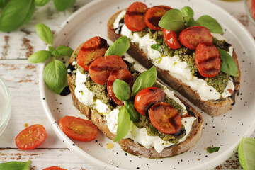 Italian sandwiches with grilled tomatoes, burrata cheese and pesto	