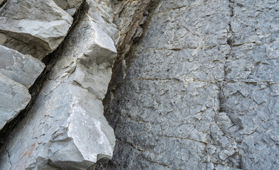 Layered rocks, flysch texture background. Sedimentary rock, striations stone pattern