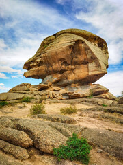 striking natural rock formation in Bayanaul, Kazakhstan. A mountain resembling a human head. For travel brochures, nature documentaries, tourism websites, scenic backdrop for adventure-themed content.