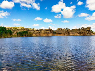 tranquil lake in Bayanaul, Kazakhstan. Layered rock formations along the shoreline. Untamed charm of this Kazakh region. For travel brochures, nature documentaries, eco-tourism websites.
