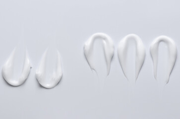 A sample of a white moisturizing cosmetic cream for the body or face with hyaluronic acid