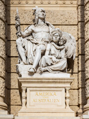 Fototapeta premium Vertical view of 19th Century allegorical figures representing America and Australia on the facade of the Naturhistorisches Museum (Natural History Museum), Vienna, Austria