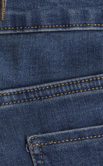 Closeup of dark blue denim jeans pocket with stitching details