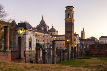 Turin, Italy. View from the Palatine Towers Archaeological Park showing the bell tower and dome of the Basilica of Turin, the Chapel of the Holy Shroud, and the Museum of Antiquities at sunset.