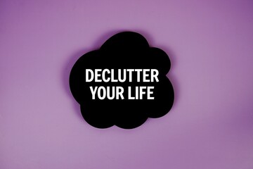 Declutter Your Life text with speech bubble top view on purple background