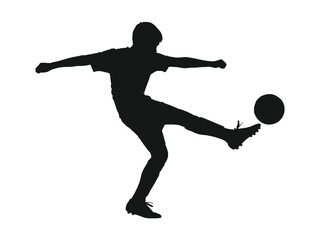 Silhouette of a soccer player kicking the ball in motion