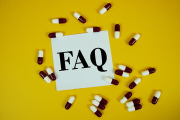 FAQ with medicine capsule on yellow background