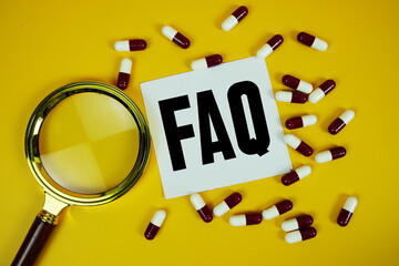 FAQ with medicine capsule and magnifying glass on yellow background