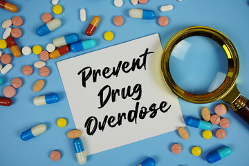 Prevent Drug Overdose with Various Colored Pills and magnifying glass on blue background