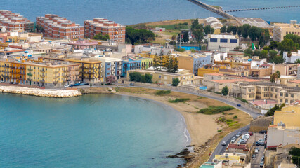 Aerial view of the small sandy beach in the historic centre of Augusta, in the province of Syracuse, Sicily, Italy. It is a town beach overlooking the Mediterranean Sea. 