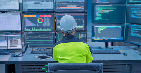 Engineer working at control room, Manager control system, Technician man monitoring program from a lot of monitor.Specialist observes analytics dashboard,operator inspects digital interface