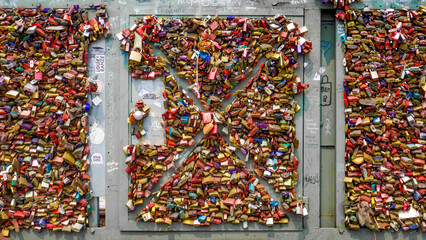 View of love locks clustered densely on the Hohenzollern Bridge, creating a colorful metallic tapestry of commitment and devotion, Cologne, Nordrhein-Westfalen, Germany.