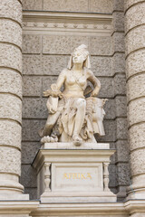 Vertical view of 19th Century allegorical figures representing Africa on the facade of the Naturhistorisches Museum (Natural History Museum), Vienna, Austria
