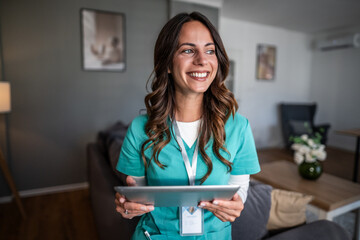 Nurse holding tablet smiling, providing professional home healthcare
