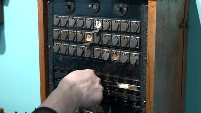 Closeup Of Technician Reconnecting Ancient Jacks On Historic Communication Equipment Panel. Media