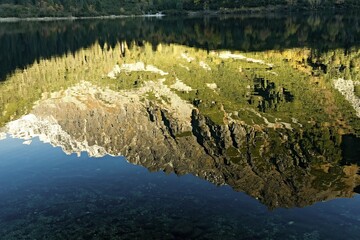 Naklejka premium The reflection of the surrounding mountains in Popradske pleso (Poprad Lake). Vysoke Tatry (High Tatras). Slovakia. Europe.