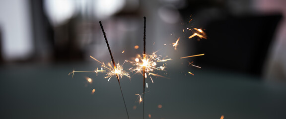 Close-up of two burning sparklers in the dusk. Horizontal background for new year's and christmas...