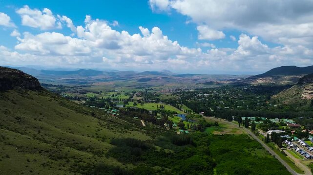 Camera panning left to right over the town of Clarens South Africa with the Maluti Mountains on both sides 4K Aerial Video