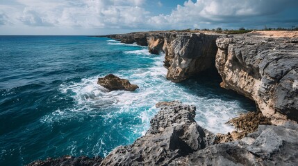Dramatic Coastal Cliffs Meet the Turbulent Ocean Waters Under a Cloudy Sky.