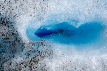 Deep blue ice crevasse inside Perito Moreno Glacier, Patagonia, Argentina. Detailed texture of ancient frozen glacial ice in Los Glaciares National Park. © Gustavo