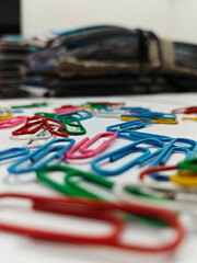 Scattered colorful paper clips on desk