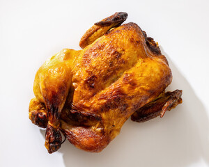 Whole roasted golden chicken on white background