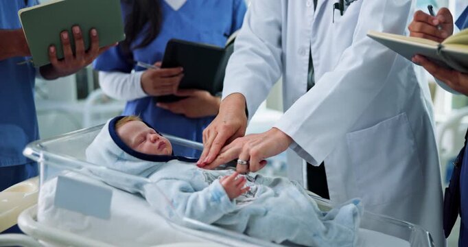 Doctor, baby doll and students in clinic, hands and notebook with paedetrician. University, medical interns or people in hospital neonatal or lesson with healthcare education, explain and dummy