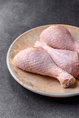 Chicken meat, raw drumsticks on the bone for grilling with salt and spices. Raw chicken drumsticks