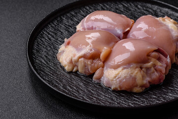 Chicken meat, raw boneless thigh fillets for grilling with salt. Raw chicken thigh fillets