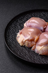 Chicken meat, raw boneless thigh fillets for grilling with salt. Raw chicken thigh fillets
