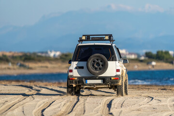Off-road vehicle driven on the beach © alicobanoglu