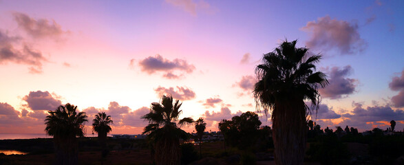Spectacular sunset at Coral Bay offers a direct view of the sun setting over the Mediterranean Sea