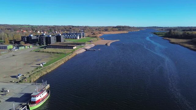 Aerial video of Haderslev Fjord with boats, buildings and scenic natural surroundings