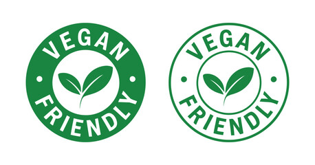 Two vibrant green circular vegan friendly badges are displayed each featuring a leaf symbol within the design promoting plant based lifestyles