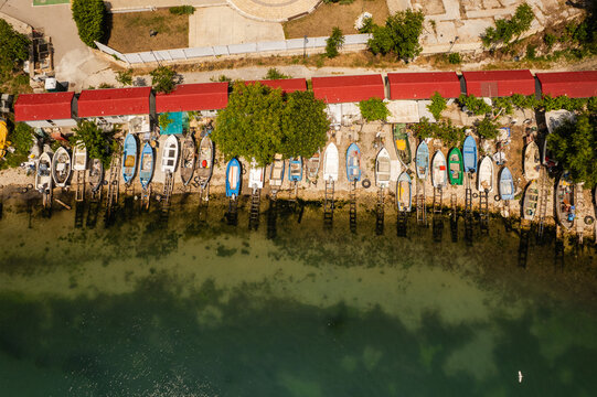 Aerial view of boats nestled along the coastline, where the vibrant red roofs meet the tranquil sea, Balchik, Dobrich Province, Bulgaria.