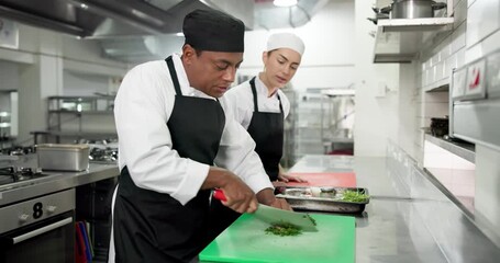 Man, woman and chopping board in restaurant, kitchen and vegetables for teaching culinary skills. People, chef and mentor with training, student or advice for meal prep, food and cooking at diner