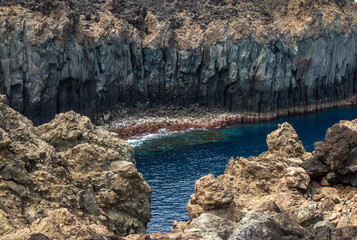 Dramatic volcanic cliffs at Alagoa Viewpoint overlooking the deep blue Atlantic Ocean on Terceira Island, Azores, Portugal, showcasing rugged lava coast scenery and natural beauty