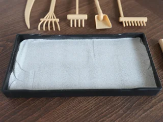 Fotobehang Zen Stenen Miniature rock garden out of sand. Meditation and relaxation set for home, tabletop.  © AngArt