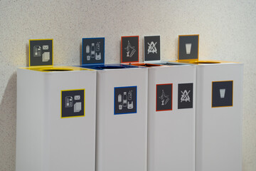 waste sorting bins for recycling, paper, plastic, food waste and non recyclables, and cups.