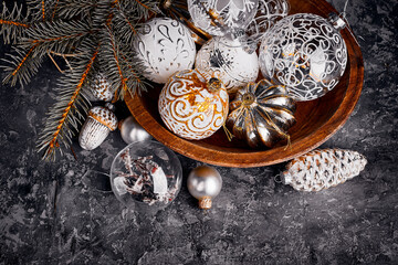 Glass toys, balls and decorations for Christmas tree in old wooden bowl in rustic style. Greeting card with copyspace. top view on grunge background