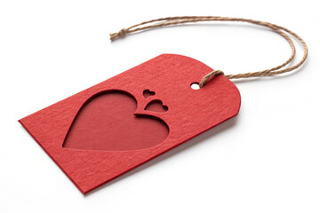 Red heart cutout tag with twine for gifts and decorations. Heart tag features intricate design for special occasions and presents. Concept heart tag adds personal touch to gifts and celebrations.