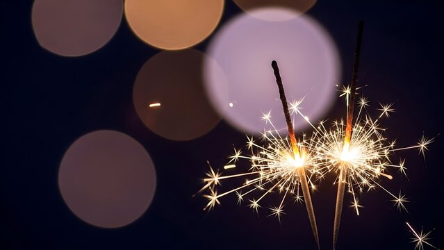 Sparklers Burning Brightly at Night with Bokeh Lights