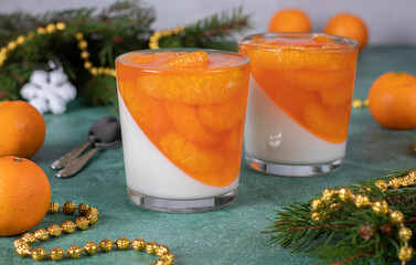 Festive Dessert Panna Cotta with tangerines in two glasses